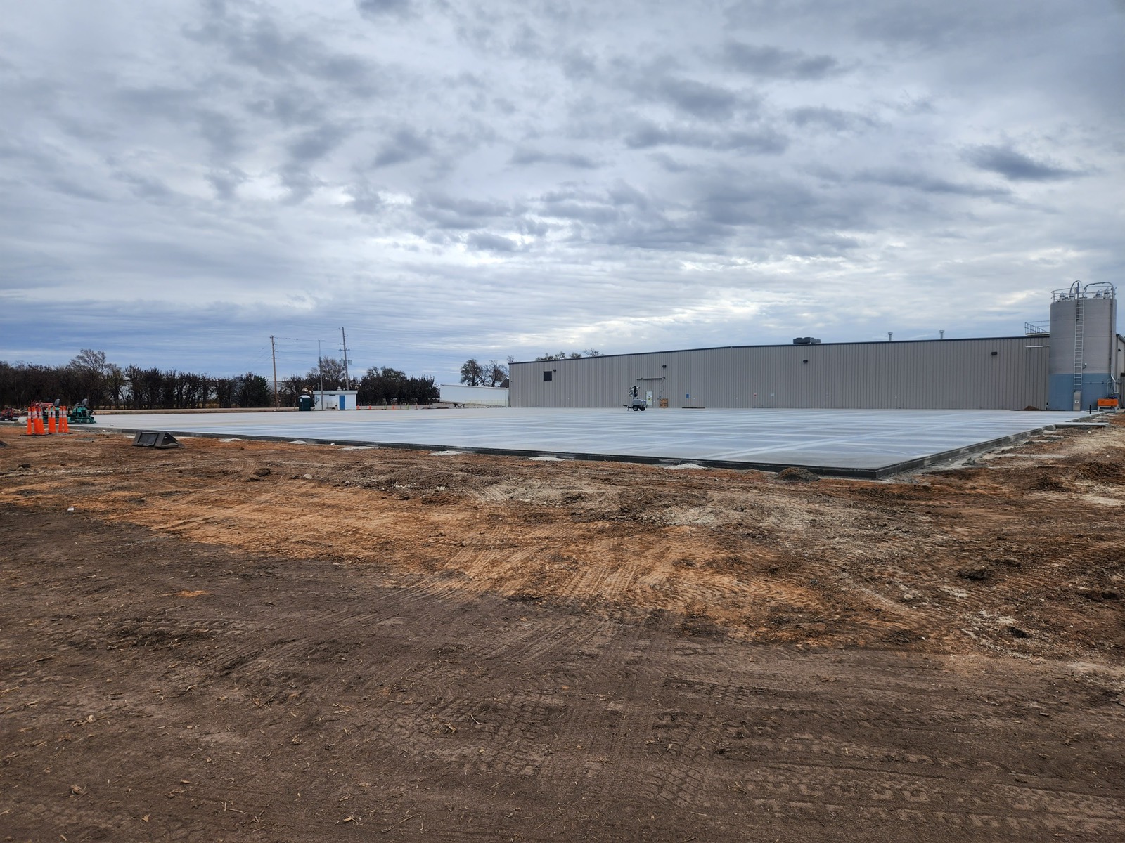 Large finished concrete slab beside a commercial building